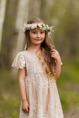 Koronkowa sukienka dla dziewczynki w kolorze herbacianej róży z delikatnymi rękawami.