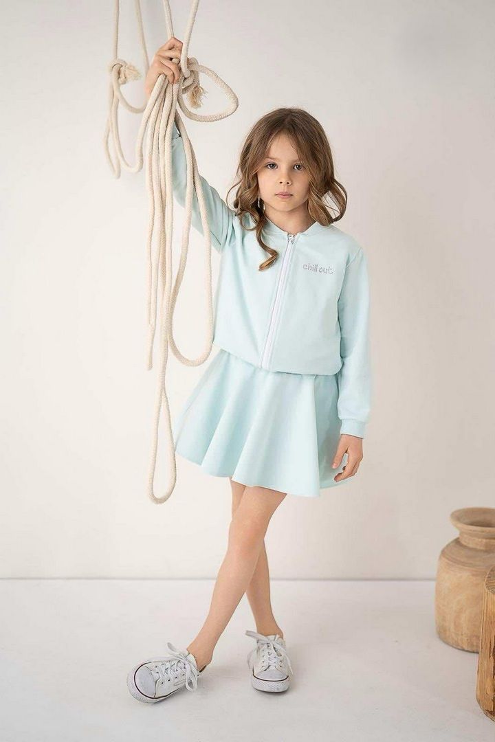 Miętowy zestaw dla dziewczynki składający się z bluzy z zamkiem i rozkloszowanej spódnicy.