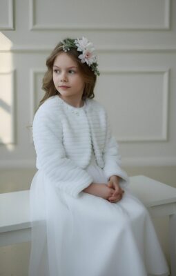 Białe bolerko dla dziewczynki z delikatnym wzorem, idealne na specjalne okazje.