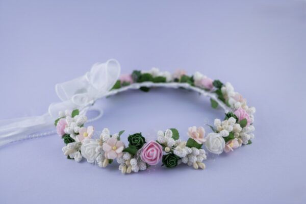 Wianek dla dziewczynki z zielonymi i różowymi kwiatami, ozdobiony białą wstążką. Idealny na uroczystości i specjalne okazje.